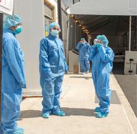 Frontline workers are in protective workwear.